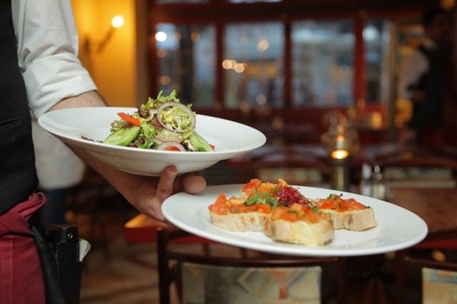 server holding two dishes