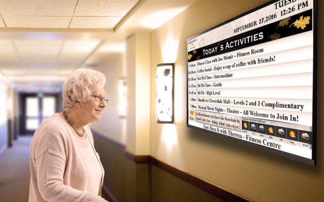 senior viewing digital screen at retirement home
