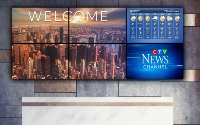 large video wall above reception desk in corporate lobby
