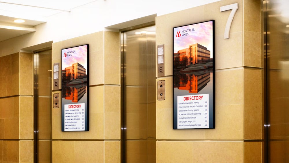two digital building directories near elevators