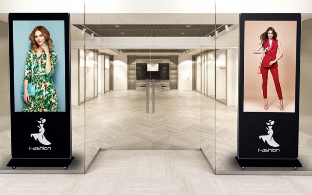 digital kiosks displaying fashion promos at retail store