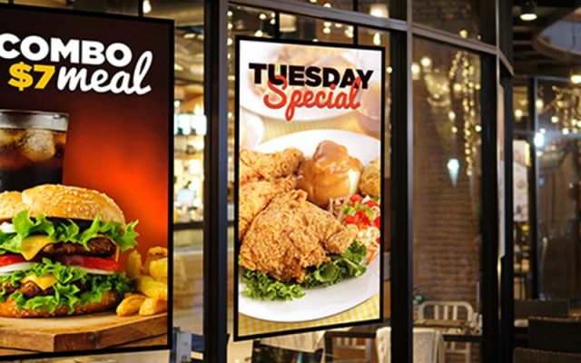digital window display screens showing fast food promotions