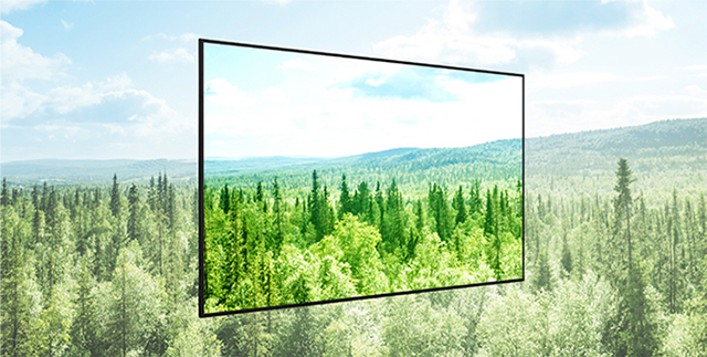 LG signage display in front of a green forest landscape